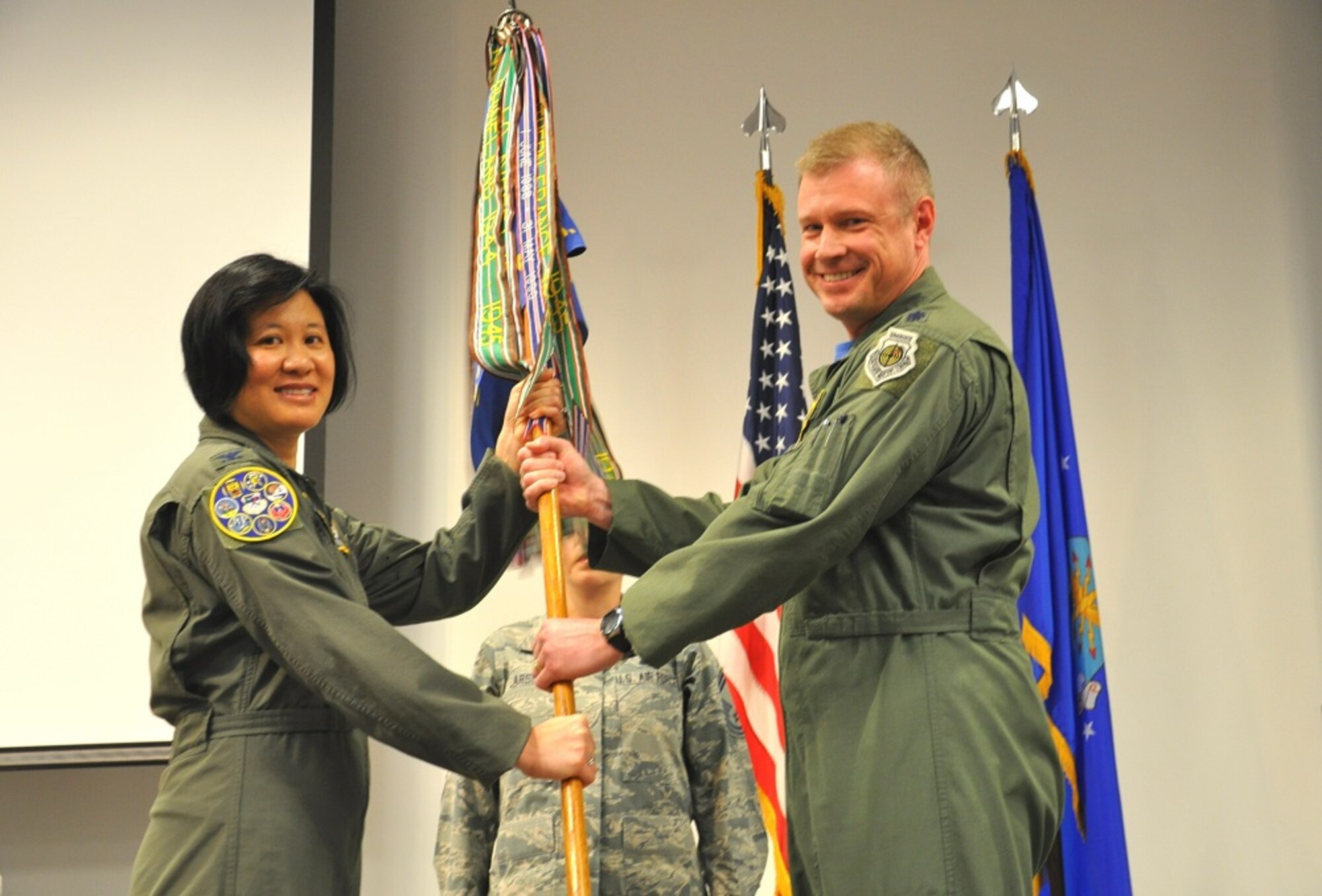 Col. Janette Thode, 340th Flying Training Group commander, accepts the guidon from Lt. Col. Allen Duckworth, outgoing 97th Flying Training Squadron commander. (U.S. Air Force photo by Debi Smith)