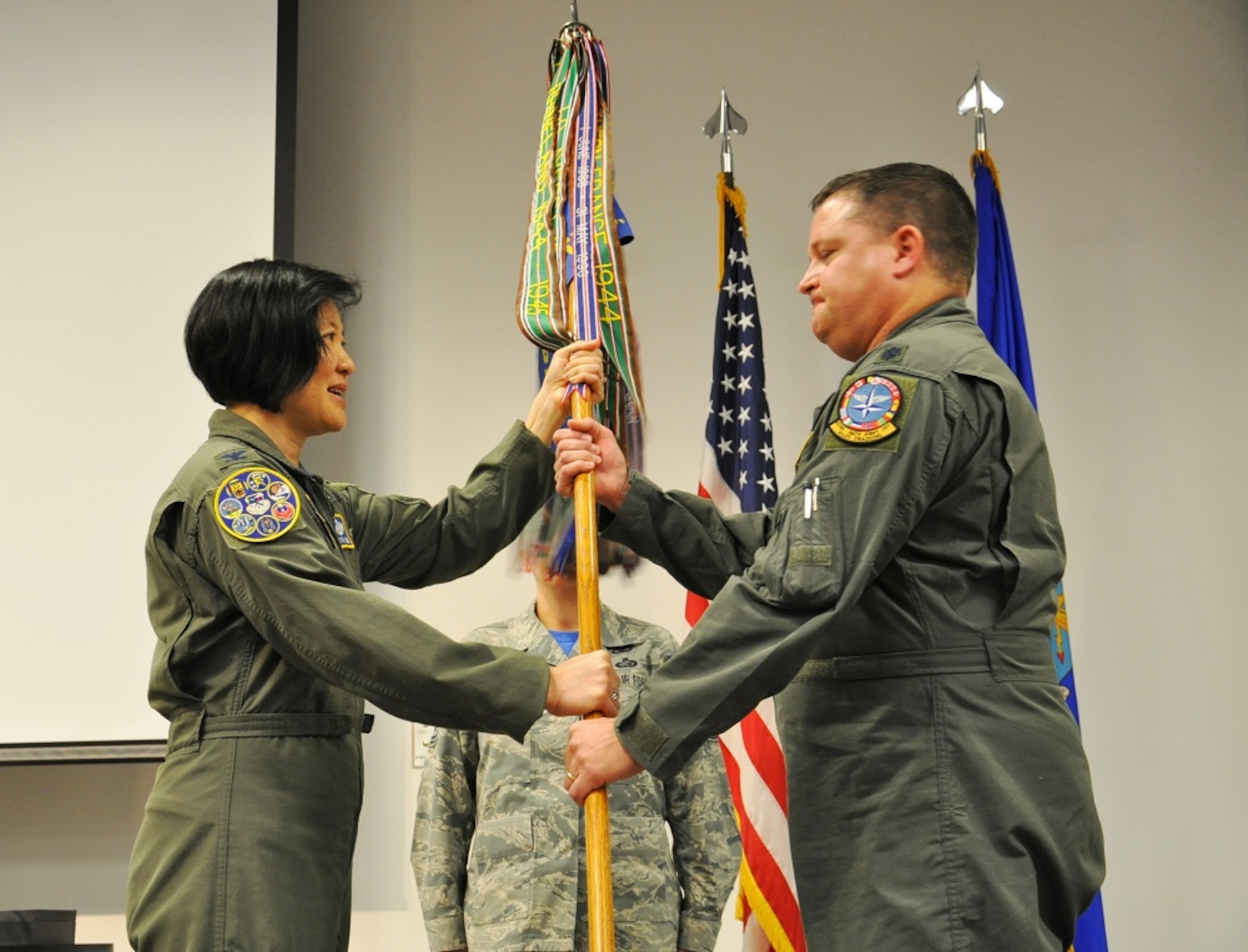 New 97th Flying Training Squadron Commander Lt. Col. Michael Rose accepts the guidon, and command of the squadron, from 340th Flying Training Group Commander Col. Janette Thode. (U.S. Air Force photo by Debi Smith)