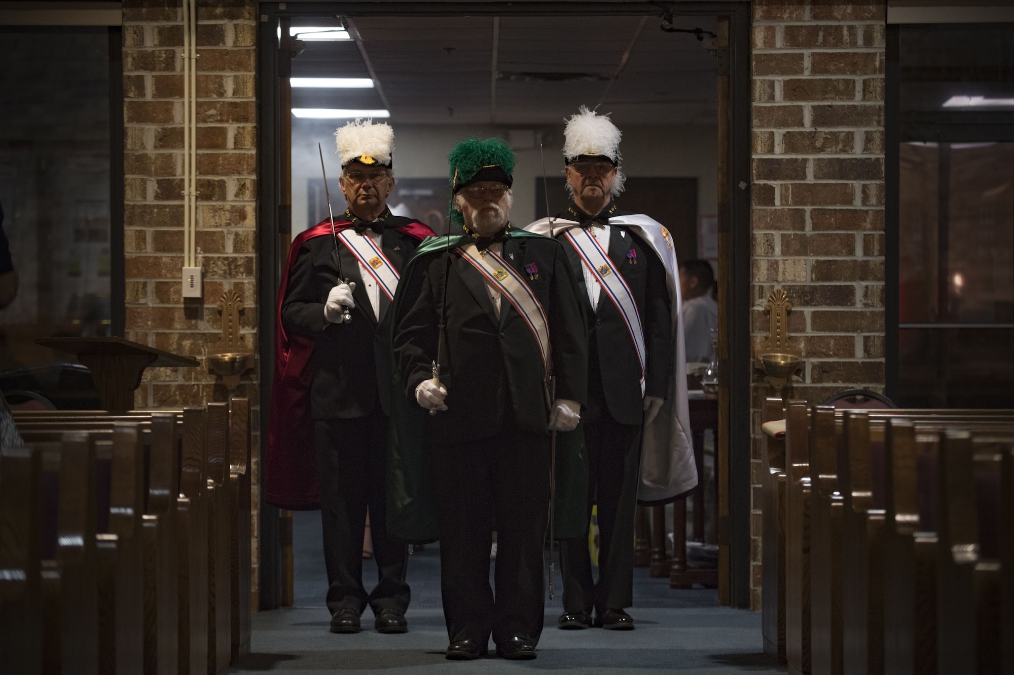Members of the Knights of Columbus, council 4913, enter into a sanctuary shortly before Bishop Robert J. Coyle, Archdiocese of the Military Services, performs a Sacrament of Confirmation ceremony, Feb. 12, 2018, at Moody Air Force Base, Ga. Confirmation is the sacrament by which Catholics believe the Holy Spirit gives them the increased ability to practice their faith in every aspect of their lives and to witness Christ in every situation.  The Sacrament of Confirmation helps a person remain faithful to his or her baptismal commitment to witness to Christ and to serve others. (U.S. Air Force photo by Senior Airman Daniel Snider)