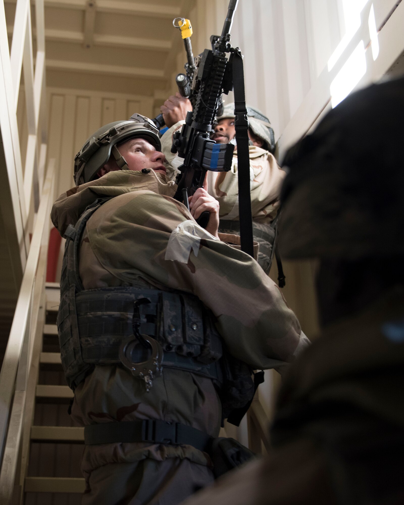 Image of Staff Sgt. Sean Richardson, 366th Security Forces Squadron response force leader, and Airmen from the 366th SFS clear a building during exercise Gunslinger 18-4 at Mountain Home Air Force Base, Idaho, February 6, 2018. The base participated in a week-long exercise to train for potential real-world contingencies. (U.S. Air Force photo by Airman 1st Class Alaysia Berry)