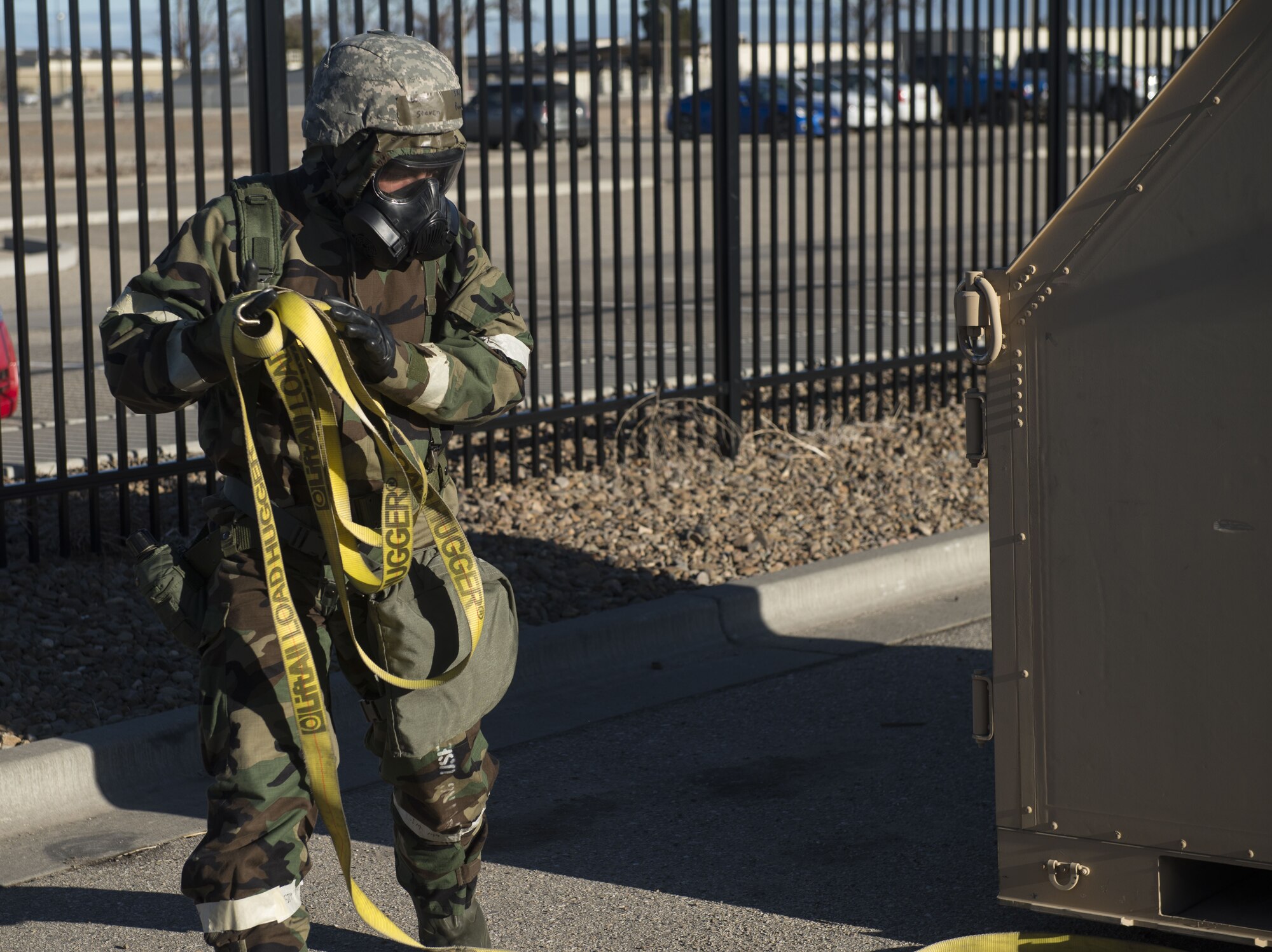 Image of Senior Airman Steven Proano, 366th Logistics Readiness Squadron vehicle operations journeyman, rolls up a cable used to bind a military-grade container to the forklift during exercise Gunslinger 18-4 Feb. 6, 2018, at Mountain Home Air Force Base, Idaho. The Phase II exercise prepared Airmen for real-world contingencies by evaluating them on how to do their job in a contingency operation. (U.S. Air Force photo by Airman 1st Class JaNae Capuno)