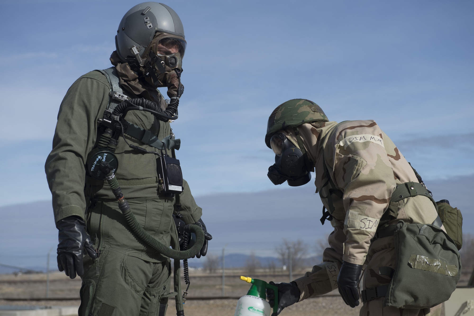 Image of A 366th Operations Support Squadron Airman simulates decontaminating a 366th Fighter Wing pilot Feb. 7, 2018, at Mountain Home Air Force Base, Idaho. The base participated in a week-long exercise to train for potential real-world contingencies. (U.S. Air Force photo by Airman 1st Class JaNae Capuno)