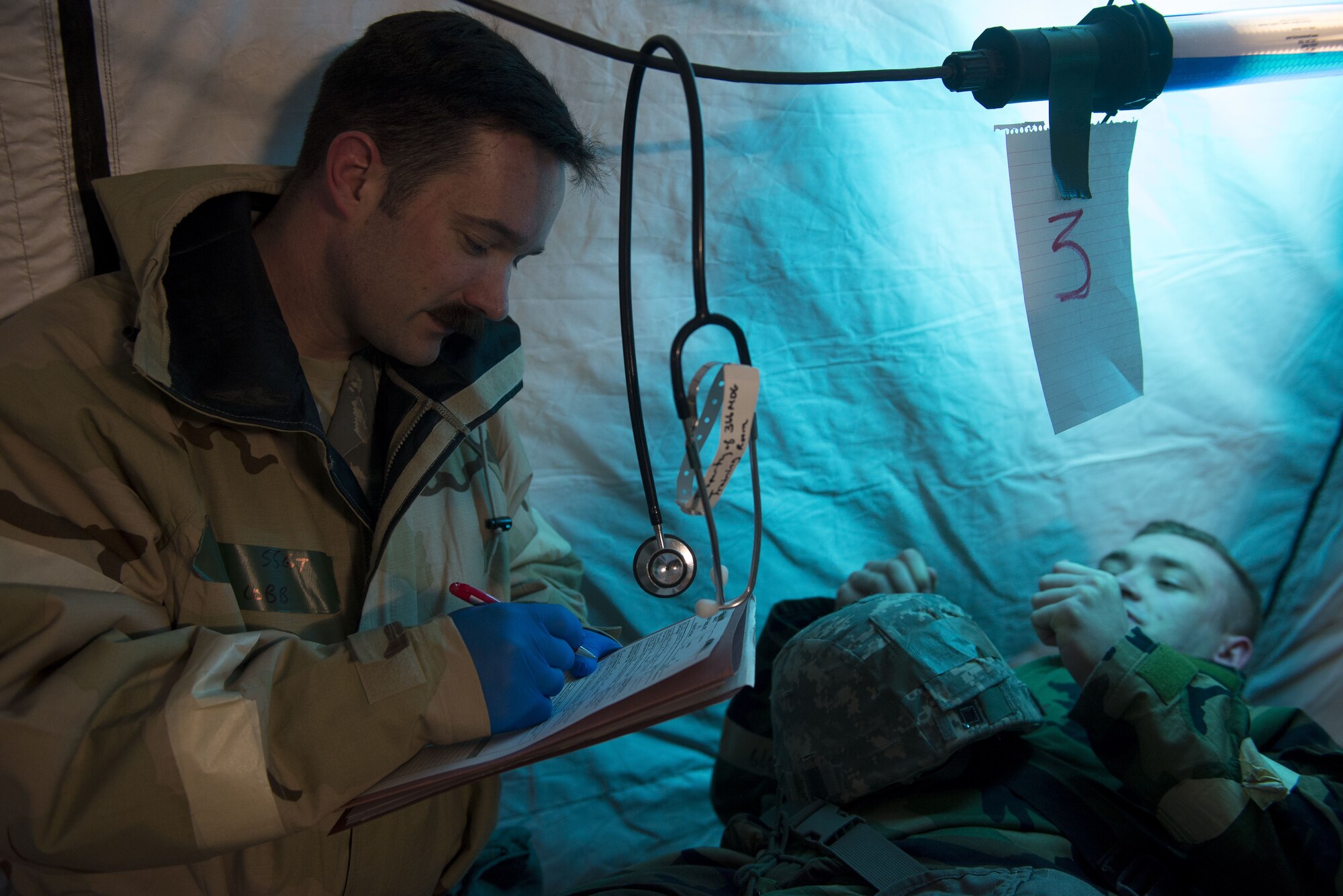 Image of Staff Sgt. Daniel Cobb, a 366th Medical Group paramedic, assesses Airman 1st Class Justin Kuhn, 366th Logistics Readiness Squadron central storage apprentice, for a simulated broken leg Feb. 7, 2018, at Mountain Home Air Force Base, Idaho. The base participated in a week-long exercise to train for potential real-world contingencies. (U.S. Air Force photo by Airman 1st Class JaNae Capuno)
