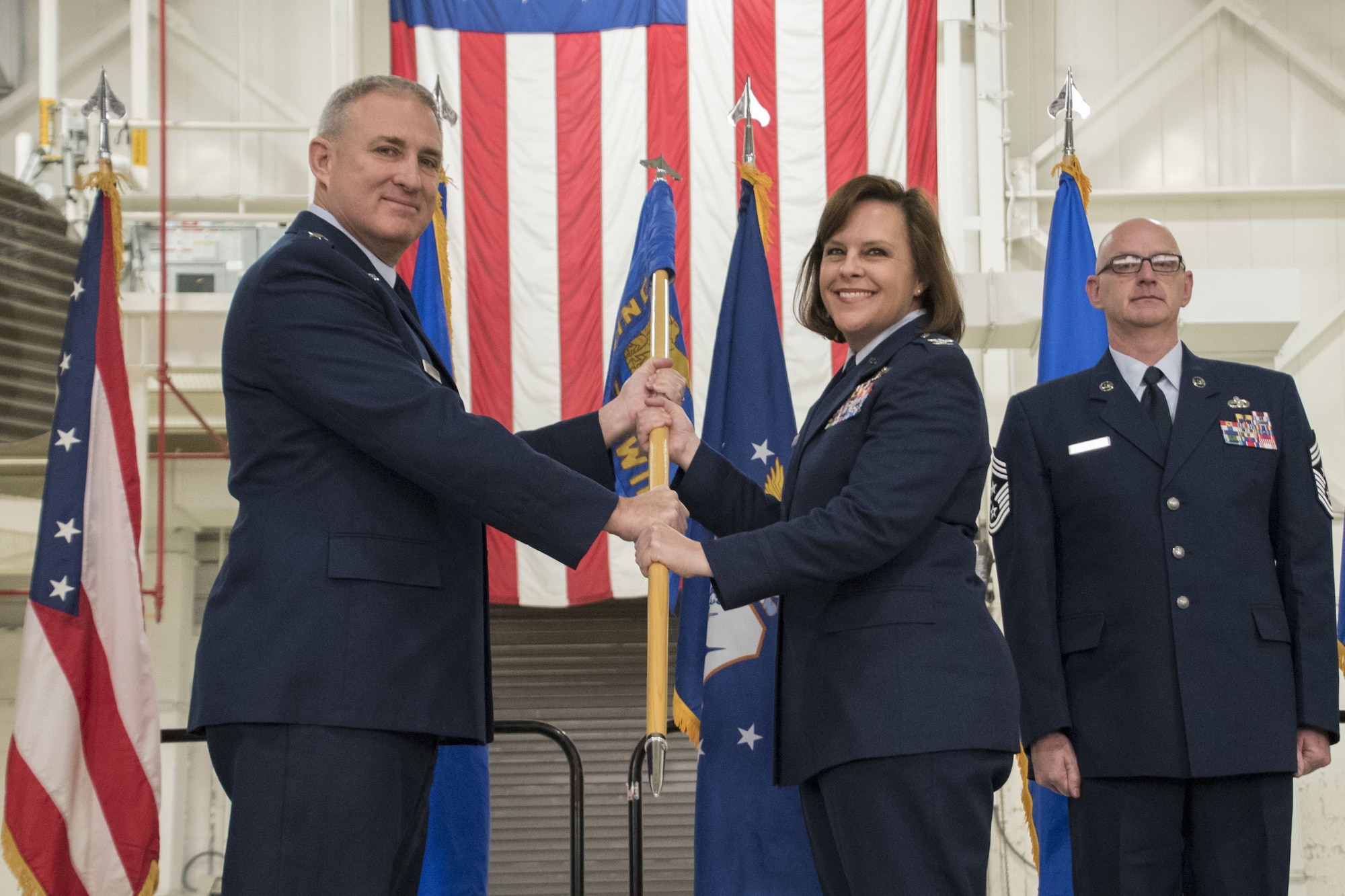 Maj. Gen. Stephen E. Malkovich, the Commander of the Ohio Air National Guard, passes the ceremonial guidon to Col. Allison Miller at the Assumption of Command ceremony Feb. 3, 2018, at the 179th Airlift Wing, Mansfield, Ohio. Col. Miller is the first female commander of an Ohio Air Guard unit