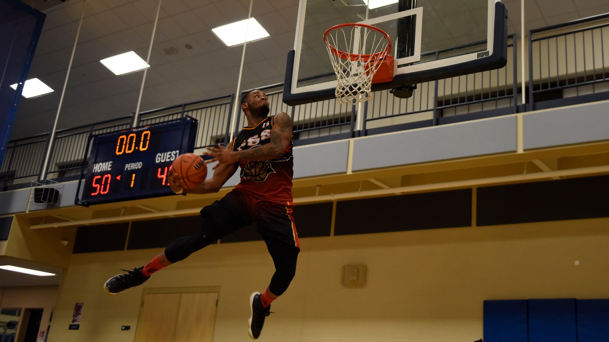 Senior Airman Andre Davis, 92nd Force Support Squadron Intramural Basketball team captain, celebrates his team’s victory with dunks following the basketball season championship at Fairchild Air Force Base, Washington, Feb. 7, 2018. The 92nd FSS and the 336th Training Group basketball teams competed for the championship.  (U.S. Air Force photo/Airman 1st Class Jesenia Landaverde)