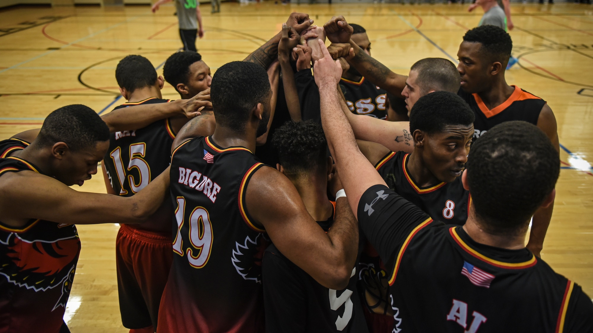 The 92nd Force Support Squadron basketball team huddles after claiming victory at the Intramural Basketball championship Feb. 7, 2018, at Fairchild Air Force Base, Washington. The game ended with a final score of 50 to 45, determining the 92nd FSS the champions.(U.S. Air Force photo/Airman 1st Class Whitney Laine)