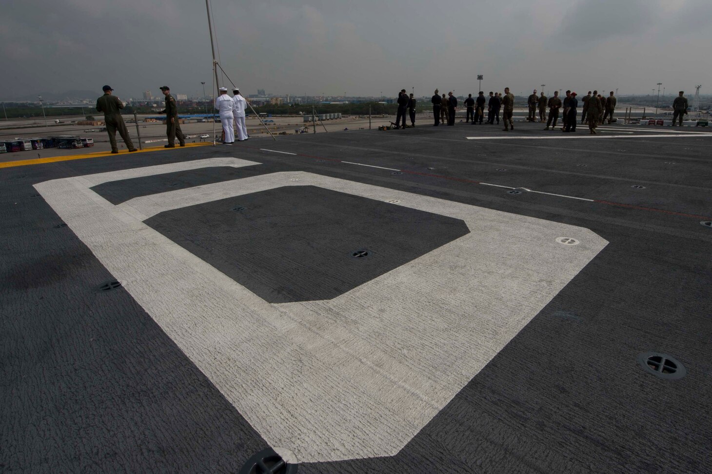 Sailors and Marines observe Laem Chebang, Thailand, from the flight deck of the amphibious assault ship USS Bonhomme Richard (LHD 6) for a scheduled port visit before beginning Cobra Gold 2018 (CG18). Cobra Gold, a Thai-U.S. co-sponsored exercise in its 37th iteration, is designed to advance regional security and ensure effective responses to regional crises by bringing together a robust multinational force to address shared goals and security commitments in the Indo-Asia-Pacific region. Bonhomme Richard is operating in the Indo-Asia-Pacific region as part of a regularly scheduled patrol and provides a rapid-response capability in the event of a regional contingency or natural disaster.