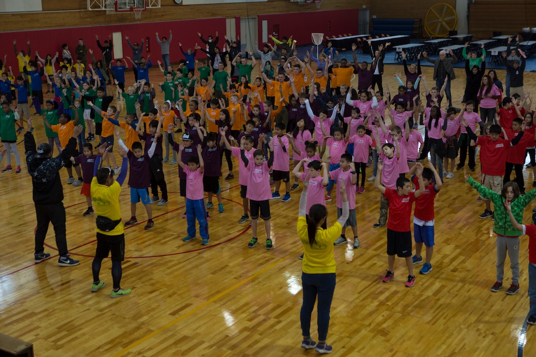 CAMP HANSEN, OKINAWA, JAPAN – Children warm-up during a Japan-U.S. Sports Exchange hosted by the Okinawa Defense Bureau Feb. 12 aboard Camp Hansen, Okinawa, Japan.