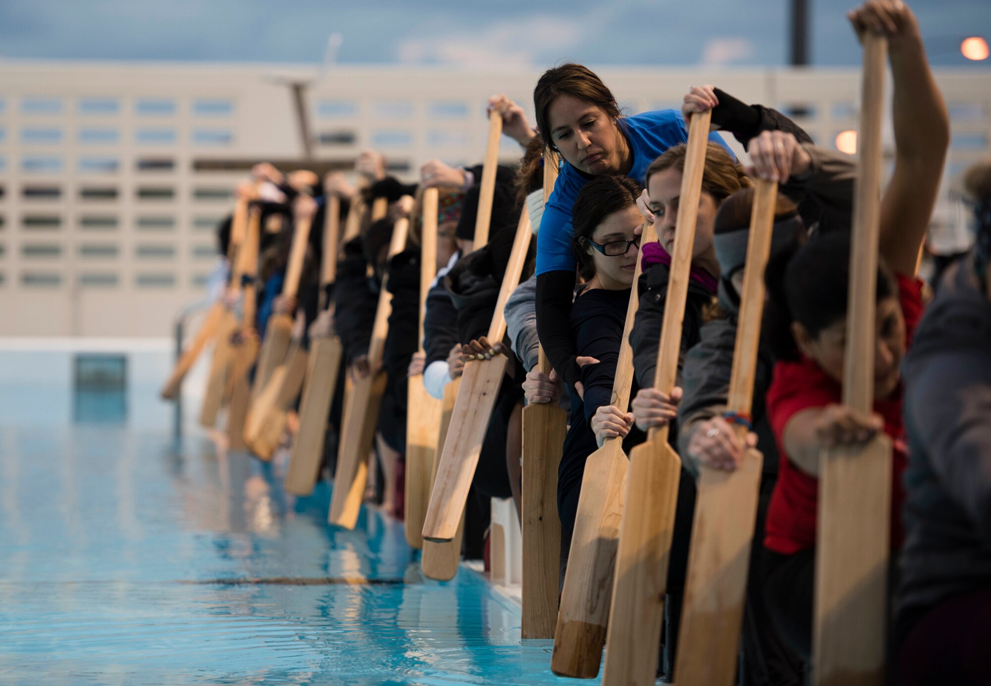 Roxane Ubence, Kadena Shoguns Women’s Dragon Boat team coach, corrects a rower’s form during practice at the Fairchild Pool Feb. 7, 2018, at Kadena Air Base, Japan. The Kadena Shoguns Women’s Dragon Boat Team is defending their Best U.S. Women’s Dragon Boat Team title against both the Army and Navy women’s dragon boat teams. (U.S. Air Force photo by Senior Airman Omari Bernard)
