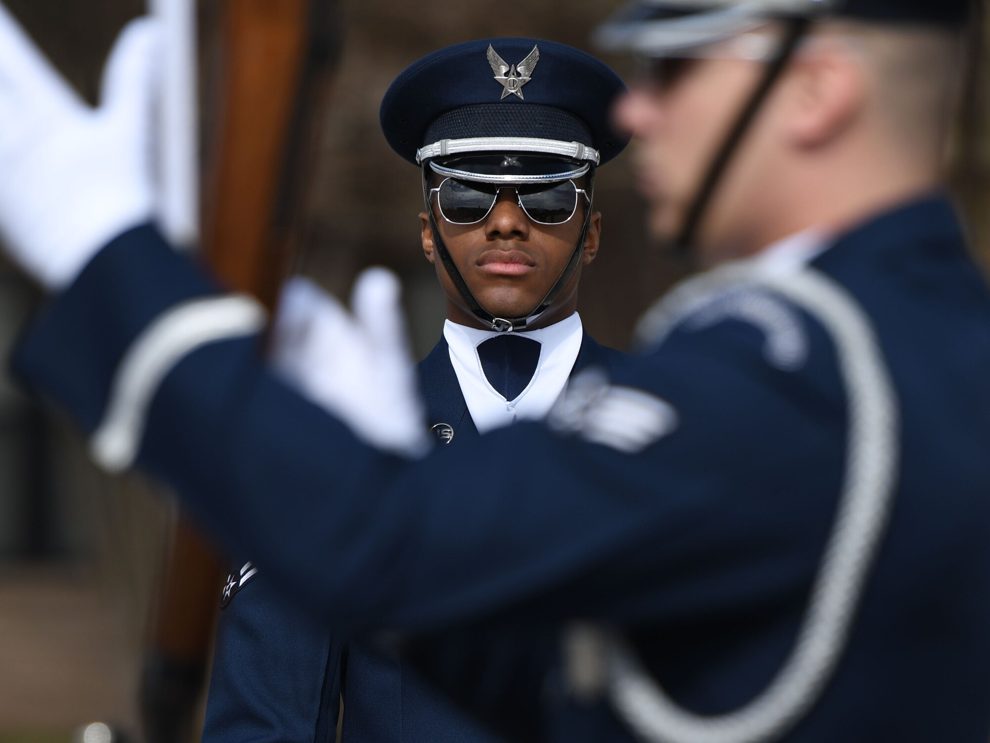 Airman 1st Class Ira Hall, U.S. Air Force Honor Guard Drill Team member, performs during the debut of the team’s 2018 routine in front of Keesler Airmen at the Levitow Training Support Facility drill pad Feb. 9, 2018, on Keesler Air Force Base, Mississippi. The team comes to Keesler every year for five weeks to develop a new routine that they will use throughout the year. (U.S. Air Force photo by Kemberly Groue)