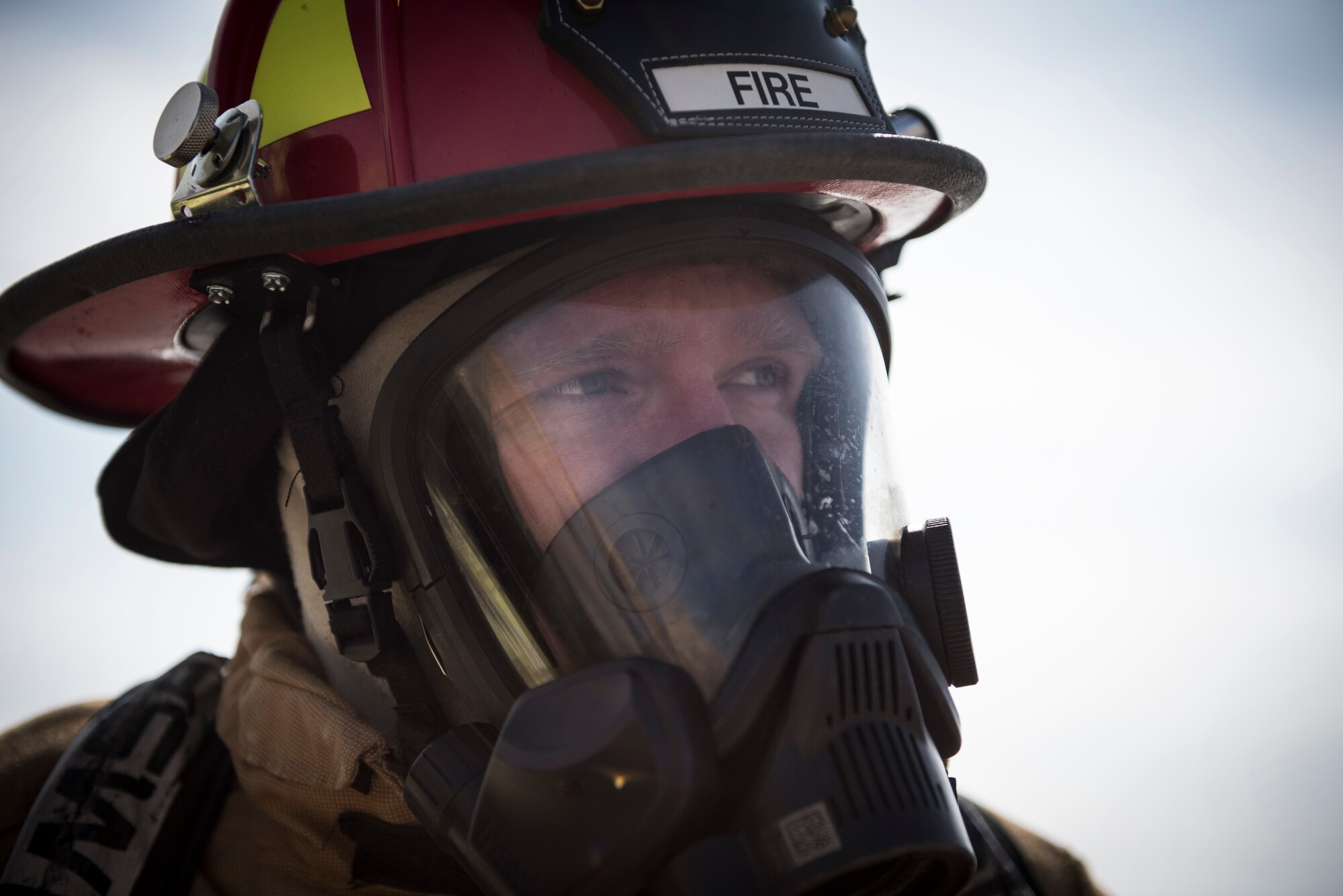 Tech Sgt. Kaleb Draper, a firefighter assigned to the 332d Expeditionary Civil Engineer Squadron, assesses a simulated incident scene during emergency egress training February 14, 2018 in Southwest Asia. Air Force firefighters train constantly for a great number of scenarios, including structure fires, aircraft crashes, and hazardous material mishaps. (U.S. Air Force photo by Staff Sgt. Joshua Kleinholz)