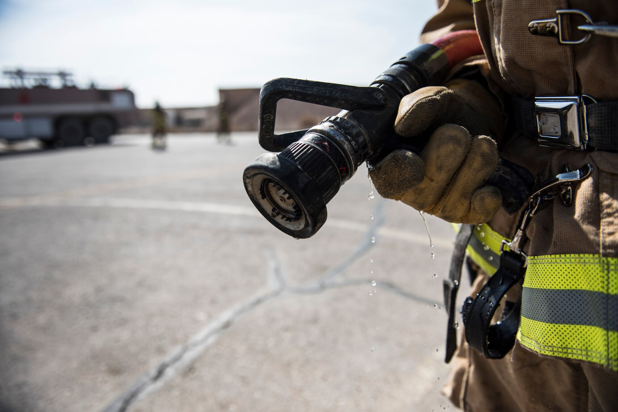 Firefighters assigned to the 332d Expeditionary Civil Engineer Squadron, respond to a simulated aircraft incident scene during emergency egress training February 14, 2018 in Southwest Asia. Special hazards associated with military aircraft require firefighters to take extra precautions when working to evacuate casualties. (U.S. Air Force photo by Staff Sgt. Joshua Kleinholz)