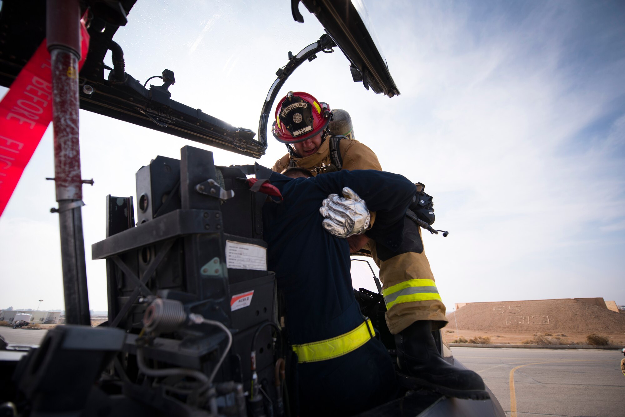 Tech Sgt. Kaleb Draper, a firefighter assigned to the 332d Expeditionary Civil Engineer Squadron, pulls a simulated casualty from the cockpit of an F-15E Strike Eagle during emergency egress training February 14, 2018 in Southwest Asia. The scenario involved a pilot who had become incapacitated and lost communication with air traffic control. (U.S. Air Force photo by Staff Sgt. Joshua Kleinholz)