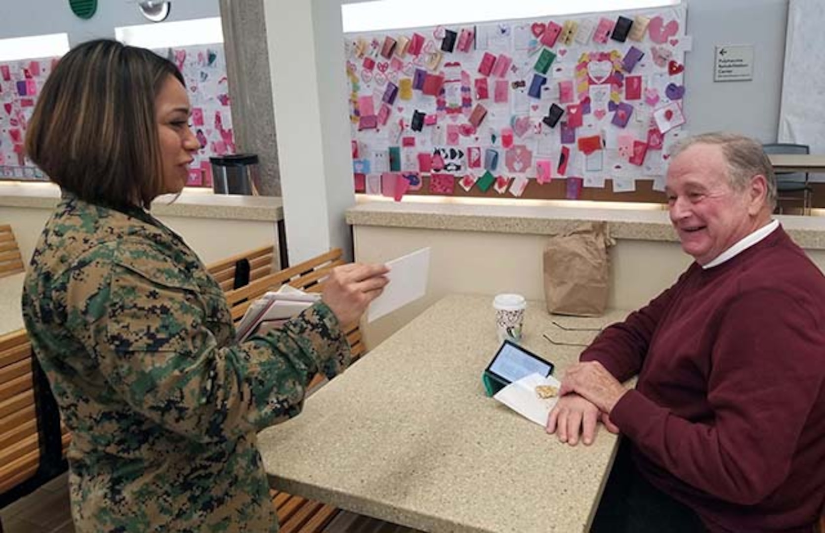 Marine Corps Gunnery Sergeant visits with veteran