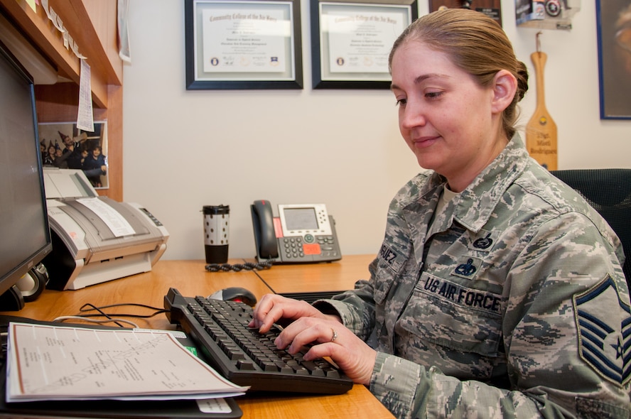 Master Sgt. Misti Rodriguez, Academic Coding Branch superintendent, inputs a transcript into the Air Force Military Personnel Data System to update an officer's record. Two Airmen at the Coding Branch, including Rodriguez, update more than 1,000 transcripts a month in support of some 130,000 total force Air Force officers.  (U.S. Air Force photo/John Harrington)