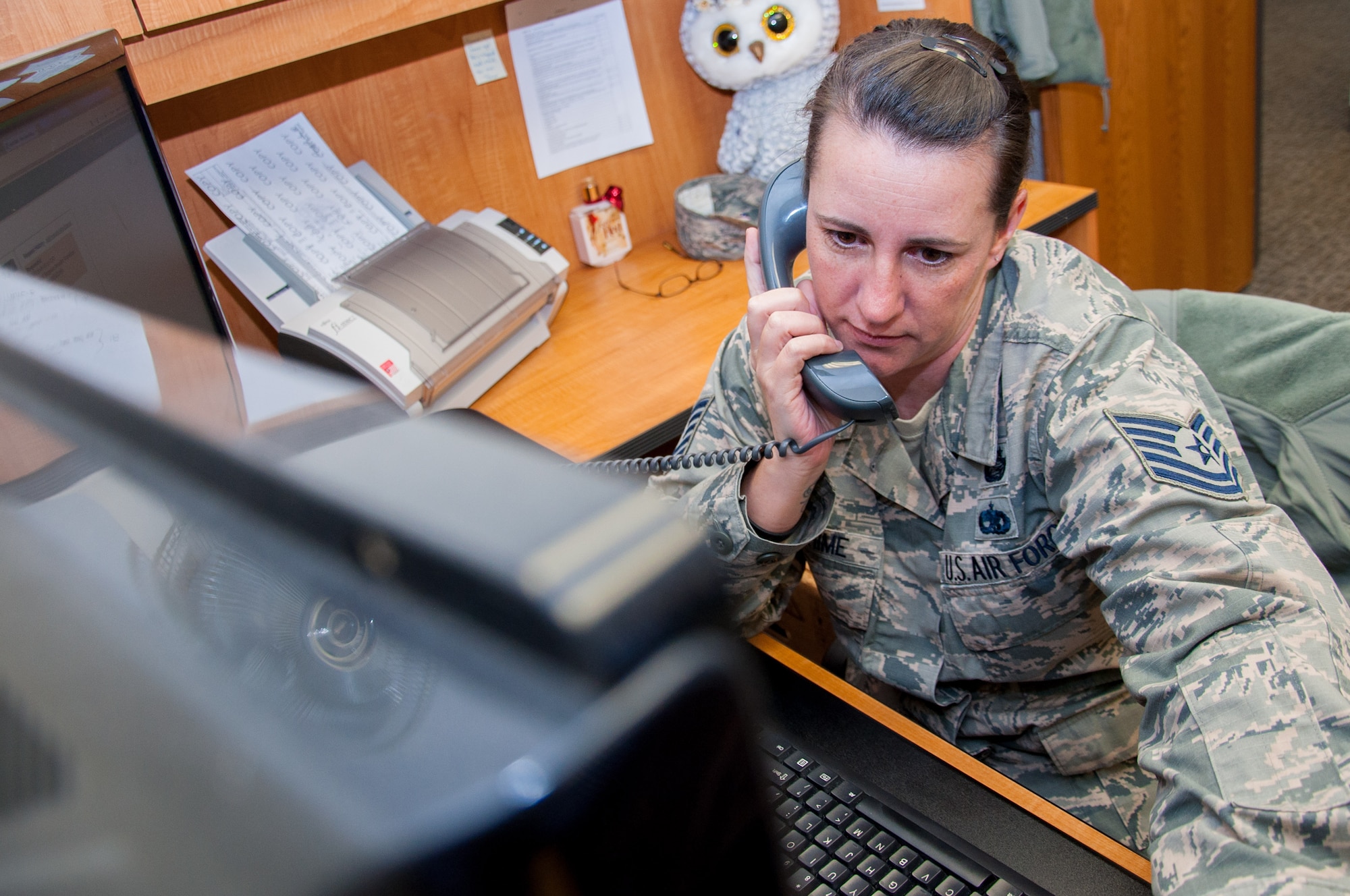 Tech Sgt. Jennifer Warehime, Academic Coding Branch noncommissioned officer-in-charge, provides phone support for an officer attempting to update his academic record. Two Airmen at the Coding Branch, including Warehime, update more than 1,000 transcripts a month in support of some 130,000 total force Air Force officers.  (U.S. Air Force photo/John Harrington) (U.S. Air Force photo/John Harrington)