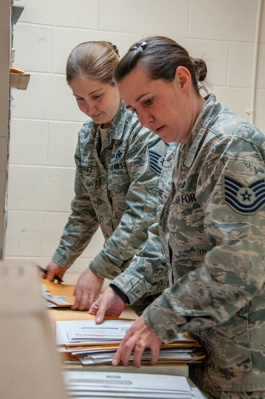 Master Sgt. Misti Rodriguez (left), Academic Coding Branch superintendent, and Tech. Sgt. Jennifer Warehime, Academic Coding Branch noncommissioned officer-in-charge, receive academic transcripts twice a week. During graduation season, they say the mail comes in large containers. Together the two update an average of between 15,000-20,000 transcripts a year in support of 130,000 total force Air Force officers including active duty, guard and reserves.  (U.S. Air Force photo/John Harrington)(U.S. Air Force photo/John Harrington)