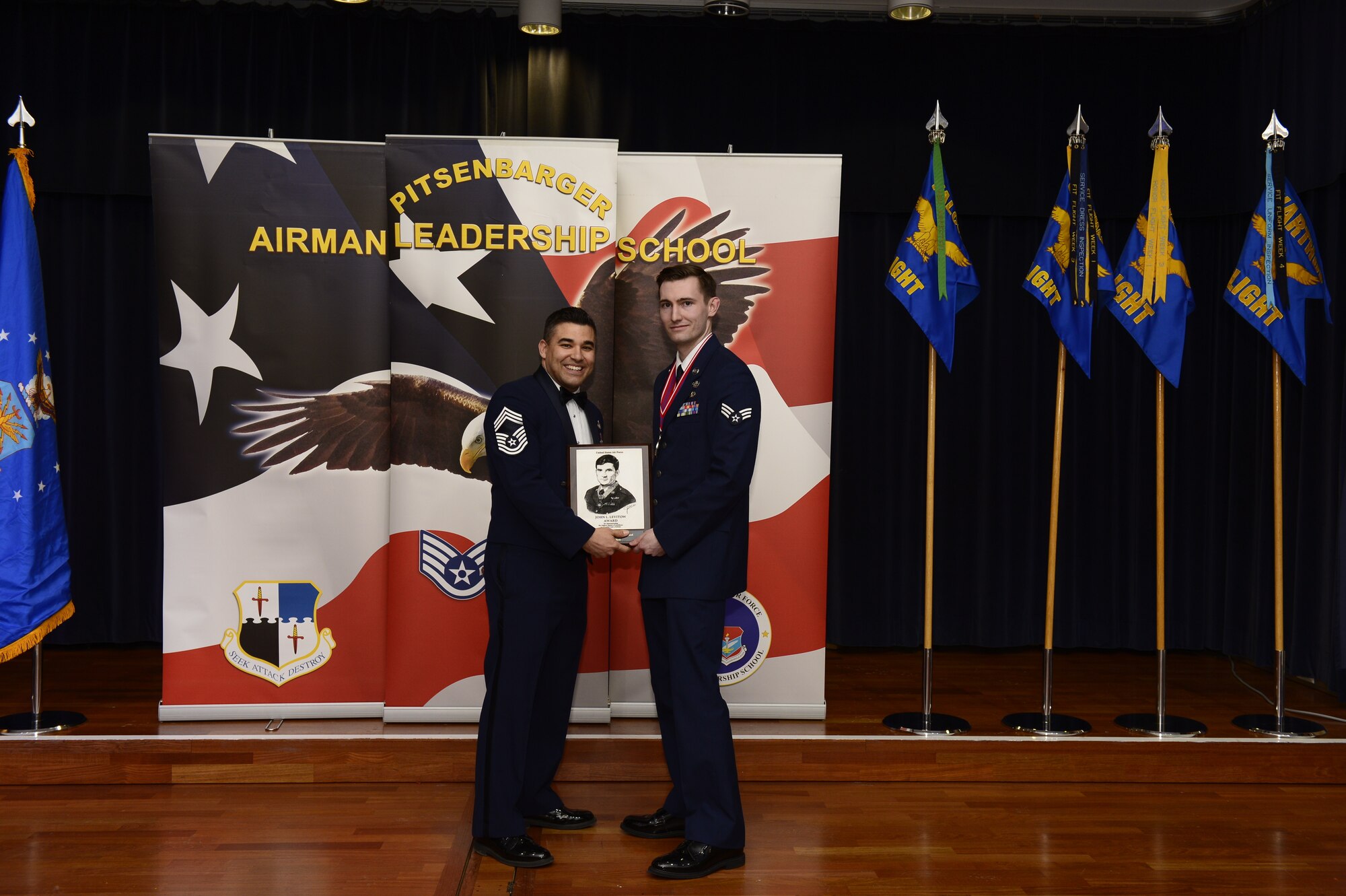 U.S. Air Force Senior Airman Alex Johnson, 52nd Civil Engineer Squadron explosive ordnance disposal journeyman, receives the John L. Levitow award during the Pitsenbarger Airman Leadership School 18-B graduation at Club Eifel on Spangdahlem Air Base, Germany, Feb. 8, 2018. The Levitow award is the highest honor given to the student who displays excellence in all categories of ALS.