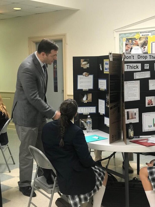 Alan Zytowski, Middle East District's Chief of Engineering and one of five USACE judges, discusses the merits of a project with an 8th grade student at Sacred Heart Academy, 13 Feb.