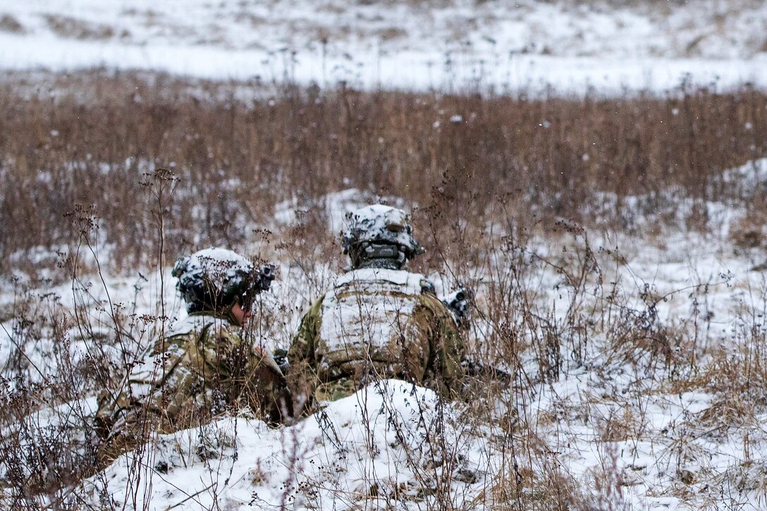Soldiers provide security from a defensive position during command post exercise Weasel.