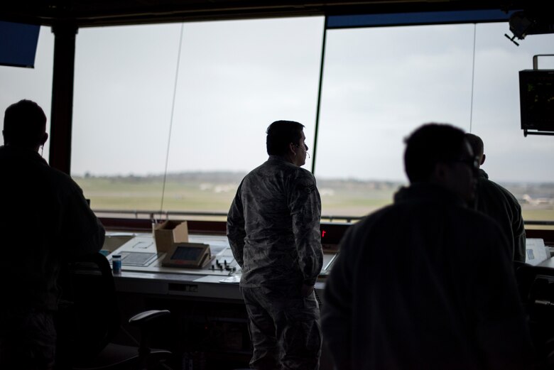 Airmen of the 48th Operations Support Squadron air traffic control tower scan the flightline at Royal Air Force Lakenheath, England, Feb. 6, 2017. The tower consists of several positions including ground control, flight data, coordinator, local control and watch supervisor. (U.S. Air Force photo/Senior Airman Malcolm Mayfield)