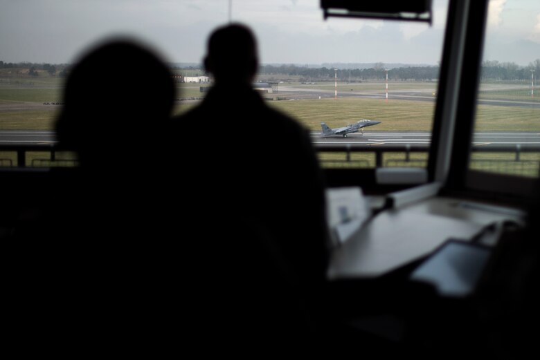 Airmen from the 48th Operations Support Squadron air traffic control tower watch as an F-15E lands at Royal Air Force Lakenheath, England, Feb. 6, 2017. The tower controls all air traffic in and out of the base. (U.S. Air Force photo/Senior Airman Malcolm Mayfield)
