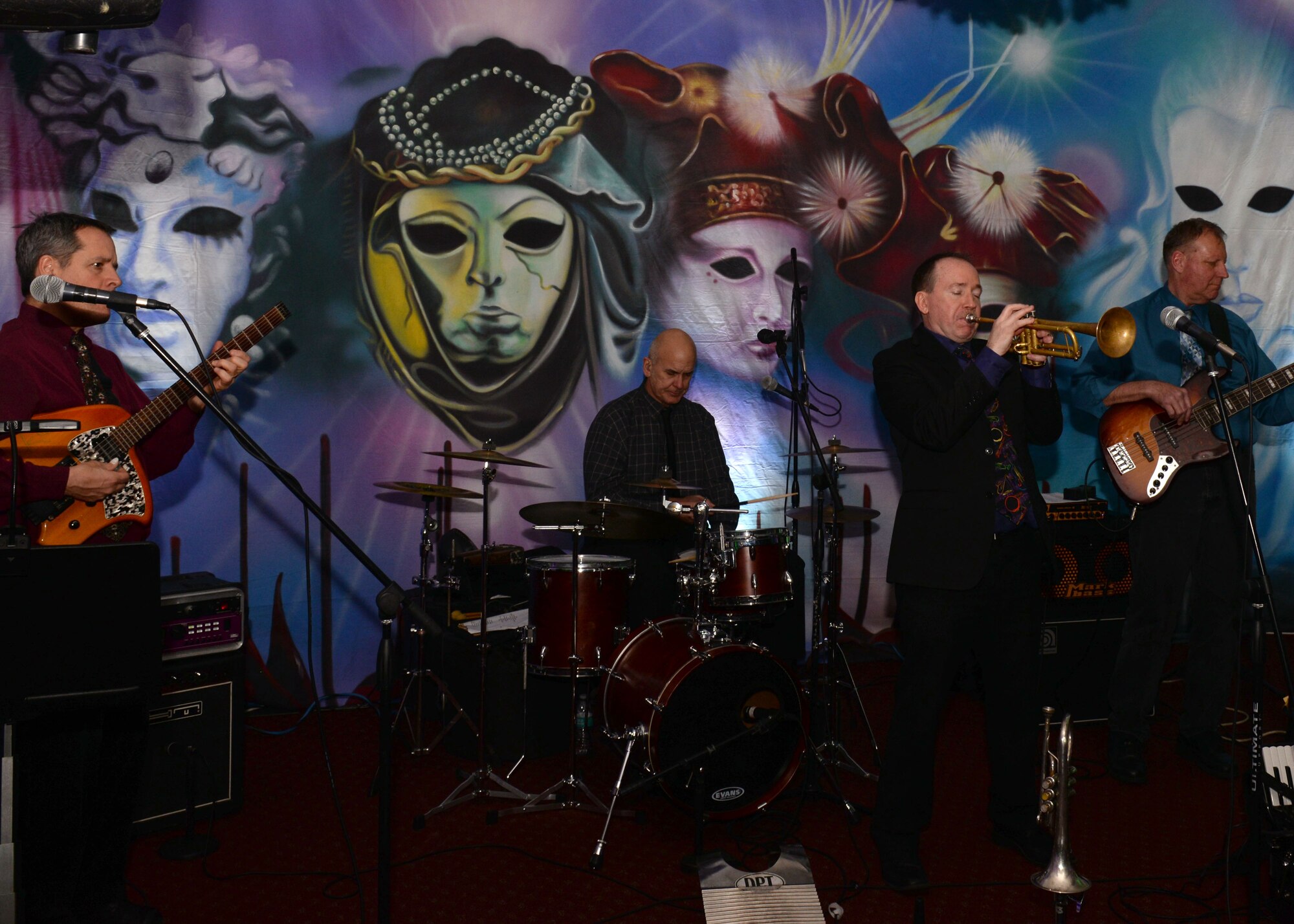Zachary Smith and the Dixie Power Trio play a set during the Mardi Gras celebration in the Fort Eustis Club at Joint Base Langley-Eustis, Va., Feb. 9, 2018. The band played New Orleans parade music to deliver a Mardi Gras atmosphere. (U.S. Air Force photo by Airman 1st Class Monica Roybal)