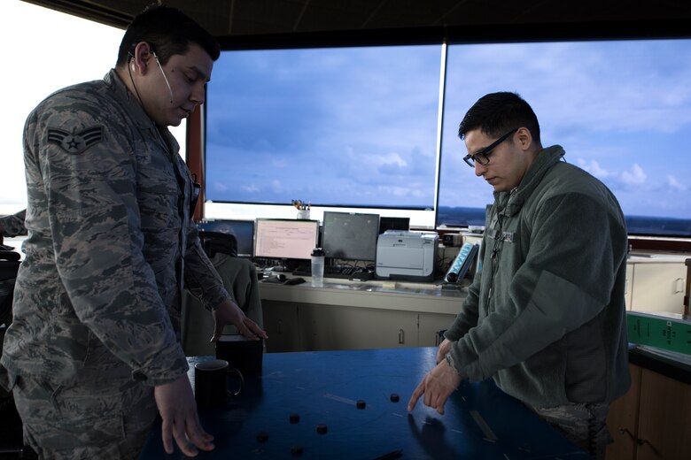 An Airman from the 48th Operations Support Squadron air traffic control tower trains a recent addition to the unit at Royal Air Force Lakenheath, England, Feb. 6, 2017. Regardless of rank or time-in-service, all Airmen in the career field must be recertified when arriving at a new base. (U.S. Air Force photo/Senior Airman Malcolm Mayfield)