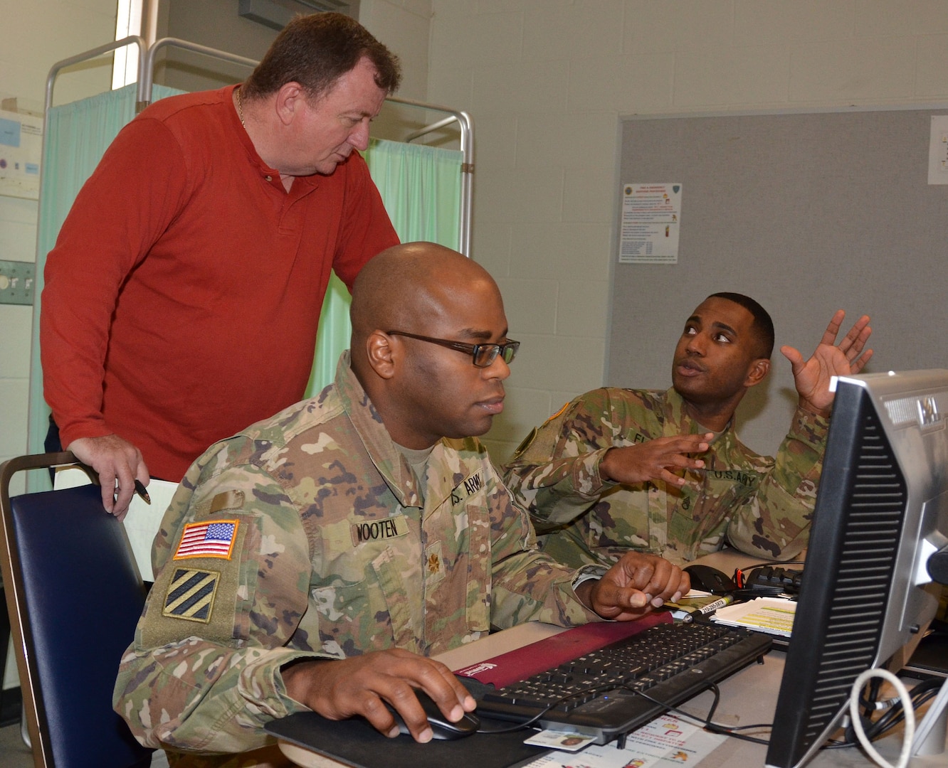 Maj. Gregory Wooten (center) provides contracting support as Mark Chase (left) and Staff Sgt. Michael Floore (right) discuss contract procedures during a humanitarian assistance disaster relief exercise Feb. 8 at Joint Base San Antonio-Camp Bullis. All are assigned to the 410th Contracting Support Brigade at JBSA-Fort Sam Houston.