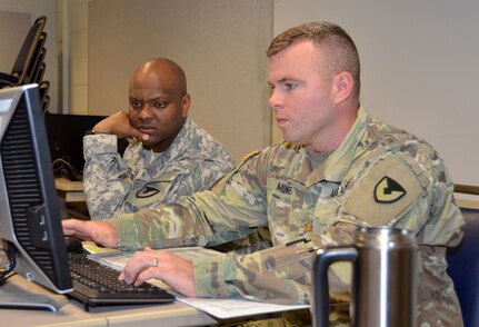 Maj. Keith Miner (right) provides contracting support as Sgt. 1st Class La Chad Jefferson (left) looks on during a humanitarian assistance disaster relief exercise Feb. 8 at Joint Base San Antonio-Camp Bullis. Miner and Jefferson are contracting officers with the 410th Contracting Support Brigade at JBSA-Fort Sam Houston.