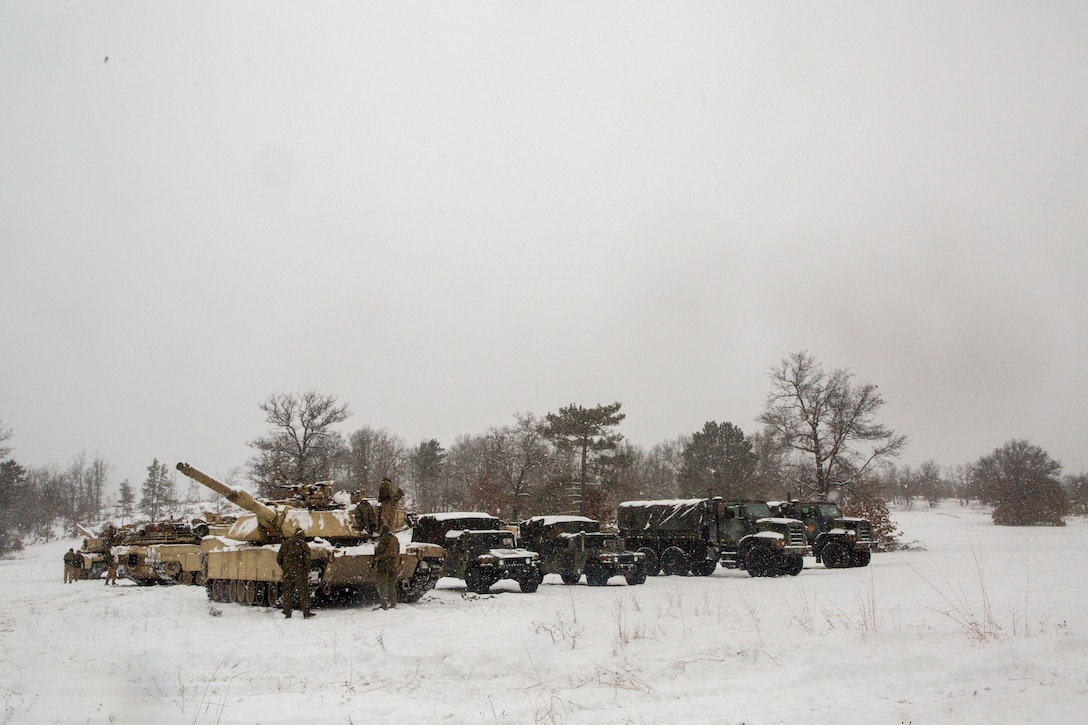Reserve Marines with Company F, 4th Tank Battalion, 4th Marine Division, stage their vehicles on training day five of exercise Winter Break 2018, aboard Camp Grayling, Michigan, Feb. 11, 2018. During Winter Break 18, Fox Co. took part in platoon and company operations that increased their operational capacity in single degree temperatures and snow covered terrain.