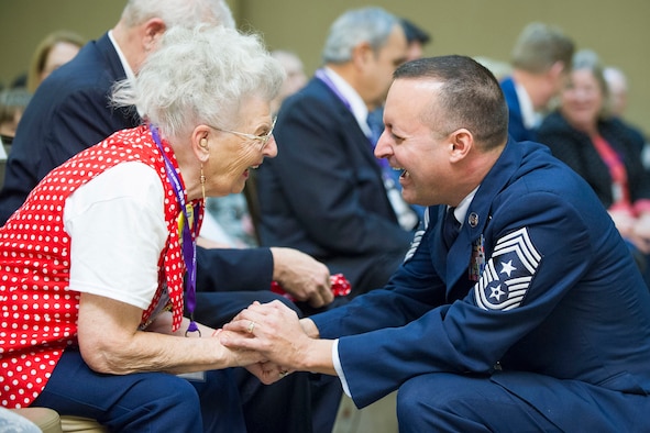 Chief Master Sgt. Michael Joseph, command chief for the Air Force Technical Applications Center, Patrick AFB, Fla., shares a hearty laugh with Mae Krier, an original member of “Rosie the Riveters” during the 2018 Women in Science and Engineering Symposium Feb. 8, 2018.  AFTAC hosted the event and invited Krier and many other high-profile women in government, education and industry to relay their success stories to young minds interested in pursuing careers in science, technology, engineering and math.  (U.S. Air Force photo by Phillip C. Sunkel IV)