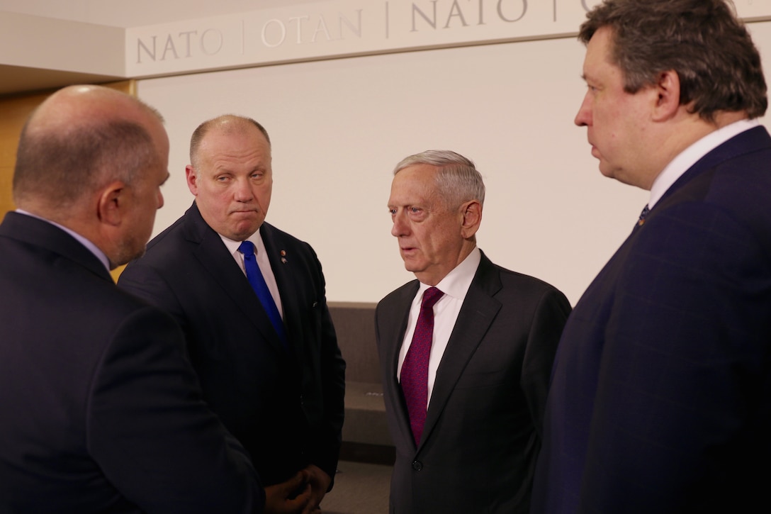 Defense Secretary James N. Mattis speaks with other defense officials in Brussels.
