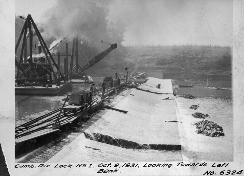 Work is ongoing at Lock and Dam 1 on the Cumberland River in Nashville, Tenn., Oct. 9, 1931. The view is towards left bank.  The U.S. Army Corps of Engineers Nashville District built Lock and Dam 1 at this location to establish a navigation channel.  The structure was later replaced by today's modern dams. (USACE Photo)