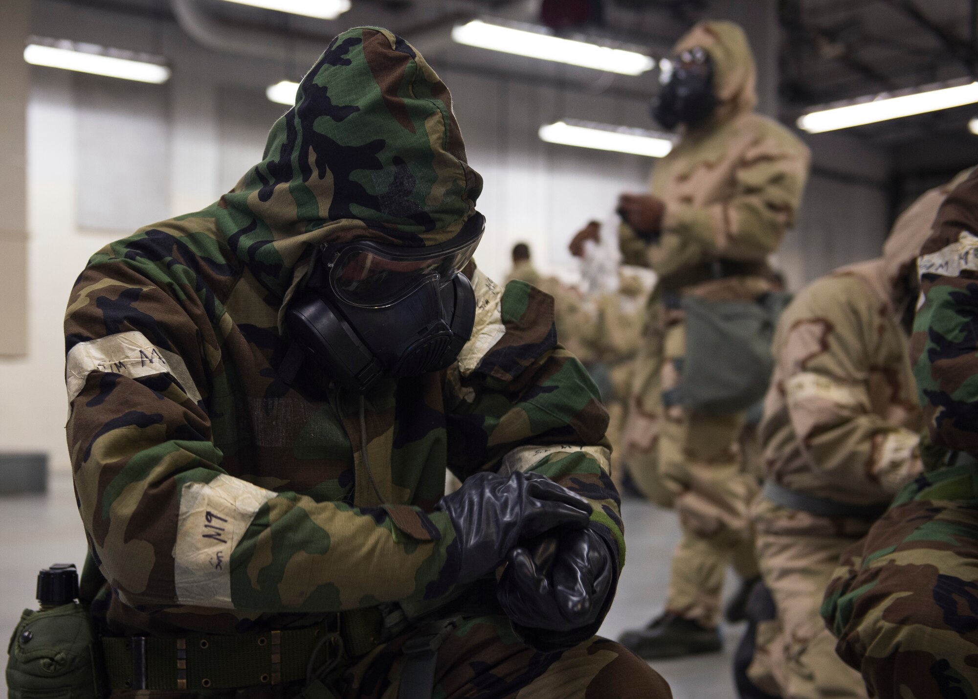 A U.S. Air Force Airman, assigned to the 633rd Civil Engineer Squadron, adjusts his gloves during Prime Base Engineer Emergency Force day training at Joint Base Langley-Eustis, Virginia, Jan. 25, 2018.