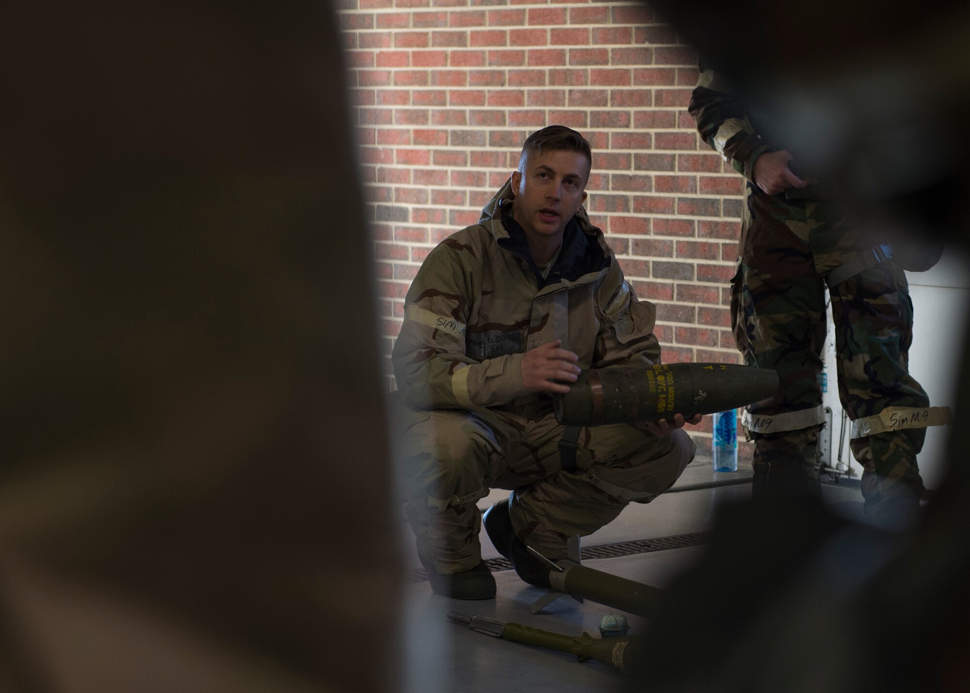 U.S. Air Force Staff Sgt. Jonathan Moline, 633rd Civil Engineer Squadron explosive ordnance disposal member, teaches Airmen about unexploded ordinance during Prime Base Engineer Emergency Force day training at Joint Base Langley-Eustis, Virginia, Jan. 25, 2018.