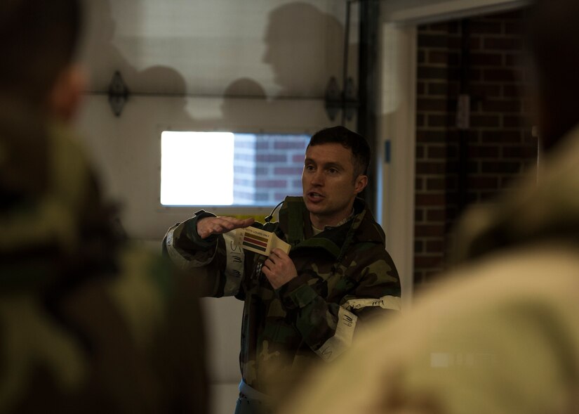 U.S. Air Force Staff Sgt. Joshua Fredrick, 633rd Civil Engineer Squadron noncommissioned officer in charge of emergency management training, teaches Airmen about decontamination procedures during Prime Base Engineer Emergency Force day training at Joint Base Langley-Eustis, Virginia, Jan. 25, 2018.