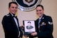 Col. Jeffrey Nelson, left, 628th Air Base Wing commander presents Senior Airman Allyson Walker-Cramer,628th Civil Engineer Squadron member, a plaque for earning the John L. Levitow Award during the class 18-B Airman Leadership School Graduation at the Charleston Club here Feb. 08, 2018. The Levitow Award is the highest honor awarded to an ALS graduate and is given to the Airman who displays the highest level of leadership qualities during the course. ALS is a five-week course encompassing lessons in the principles of supervision and management, the importance of communication and military professionalism.