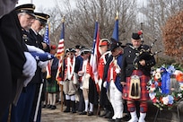 Soldiers and service members past and present, along with citizens in 18th century uniforms and attire, present flags and wreaths during a ceremony honoring the 245th birthday of our 9th President, William Henry Harrison, Feb. 9, in North Bend, Ohio.