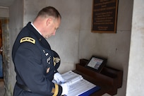 Major Gen. Patrick Reinert, 88th Readiness Division commanding general, signs his name in the guest book at the tomb of our 9th President, William Henry Harrison, Feb. 9, in North Bend, Ohio.
