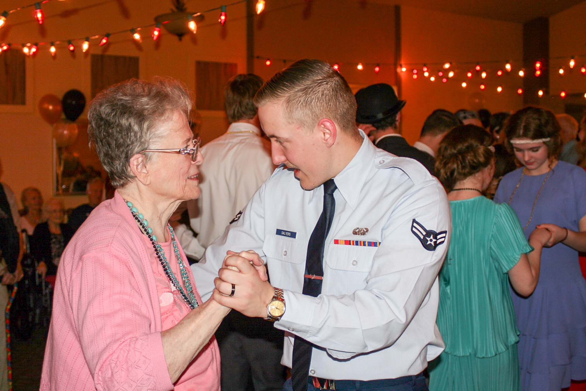Airman First Class Austyn Salyers, 75th Air Base Wing Communications and Information Directorate, dances with a resident of Chancellor Gardens Senior Living Center in Clearfield Feb. 13 at the Valentines Dance. More than 60 residents attended and mingled with Team Hill guests. Staff members noted that the Team Hill Airmen are "always the highlight of the event." (U.S. Air Force photo by Jen Eaton)