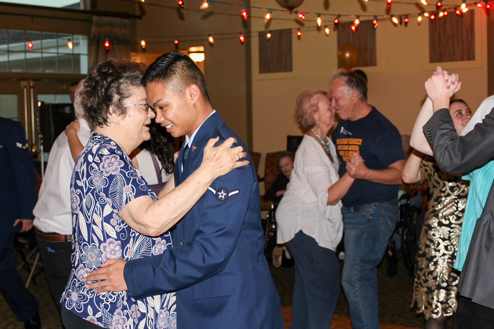 Airman Christian Gran, 75th Medical Group, dances with a resident of Chancellor Gardens Senior Living Center in Clearfield Feb. 13 at the annual Valentines Dance. More than 60 residents attended and mingled with Team Hill guests. Staff members noted that the Team Hill Airmen are "always the highlight of the event." (U.S. Air Force photo by Jen Eaton)