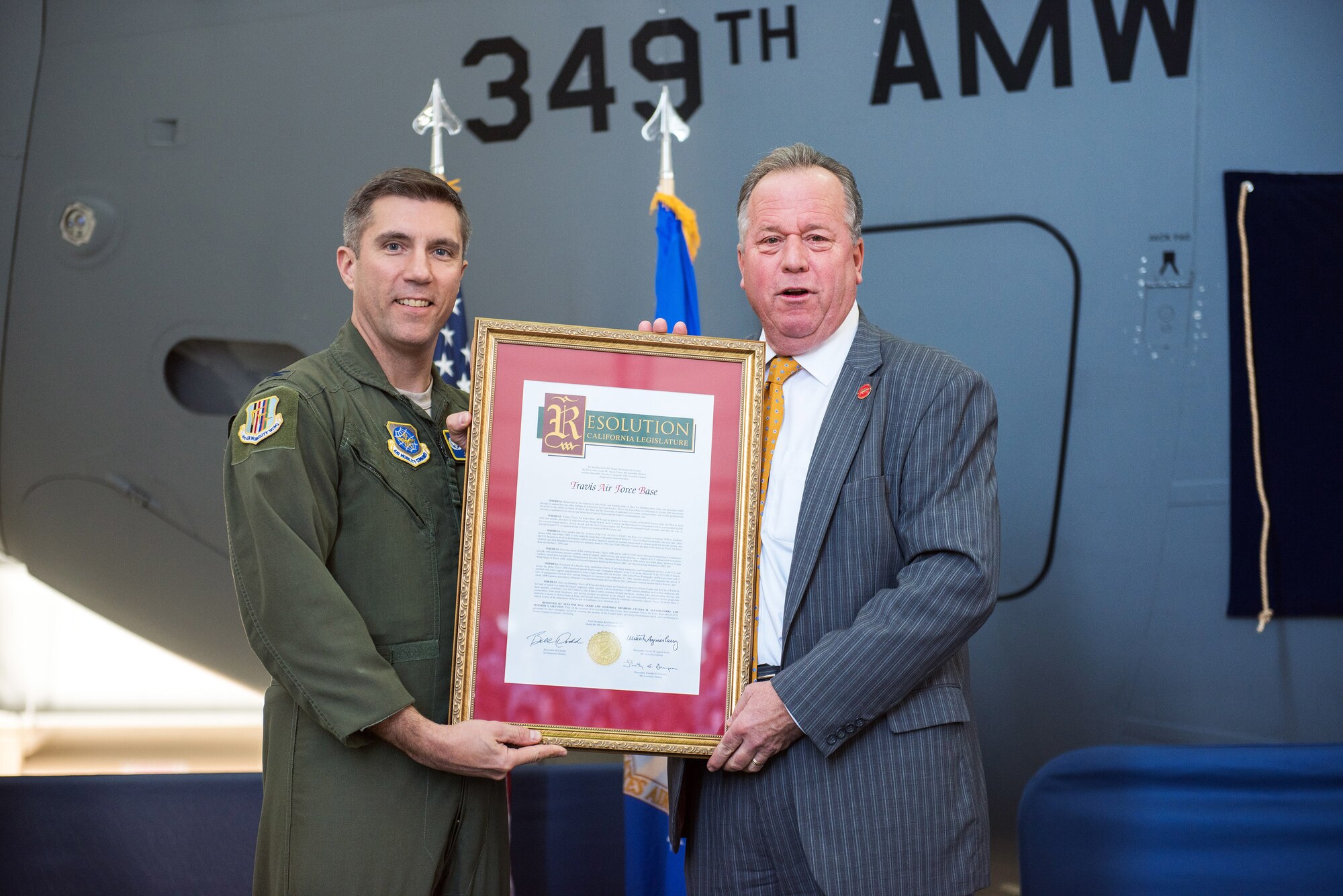 State Senator Bill Dodd (D-Napa), 3rd Senate District, presents U.S. Air Force Col. John Klein, 60th Air Mobility Wing commander a certificate during the 75th Anniversary kickoff celebration at Travis Air Force Base, Calif., Feb. 8, 2018. The celebration featured the inaugural unveiling of the 75th Anniversary logo on a C-17 Globemaster III. Travis is celebrating 75 years as a major strategic logistics hub for the Pacific and integral part of global power projection for the total force. (U.S. Air Force photo by Louis Briscese)