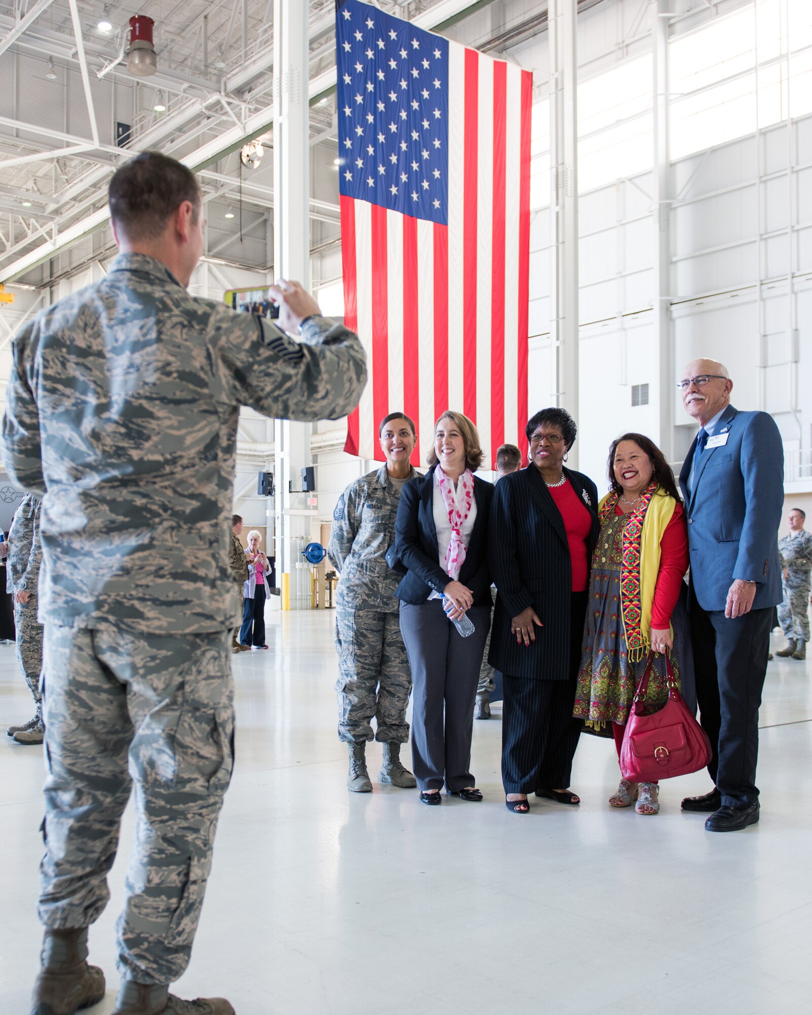 An Airman takes a photo during the 75th Anniversary kickoff celebration at Travis Air Force Base, Calif., Feb. 8, 2018. The celebration featured the inaugural unveiling of the 75th Anniversary logo on a C-17 Globemaster III. Travis is celebrating 75 years as a major strategic logistics hub for the Pacific and integral part of global power projection for the total force. (U.S. Air Force photo by Louis Briscese)