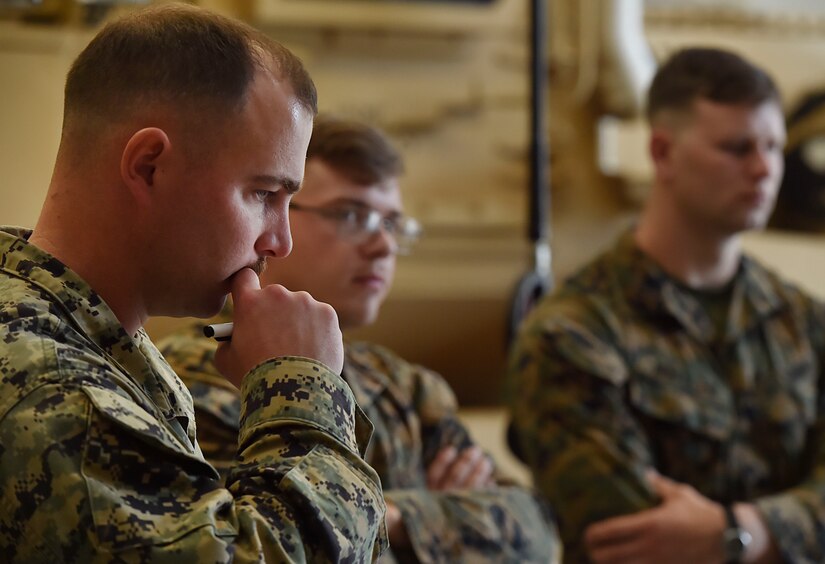 U.S. Marine Corps Staff Sgt. Justin Golden, Detachment 3 Supply Company, Combat Logistics Battalion 451, listens to U.S. Marine Corps reservists present a tactical convoy operation brief as part of a three day training event at Joint Base Charleston’s Weapons Station Feb. 11, in South Carolina.