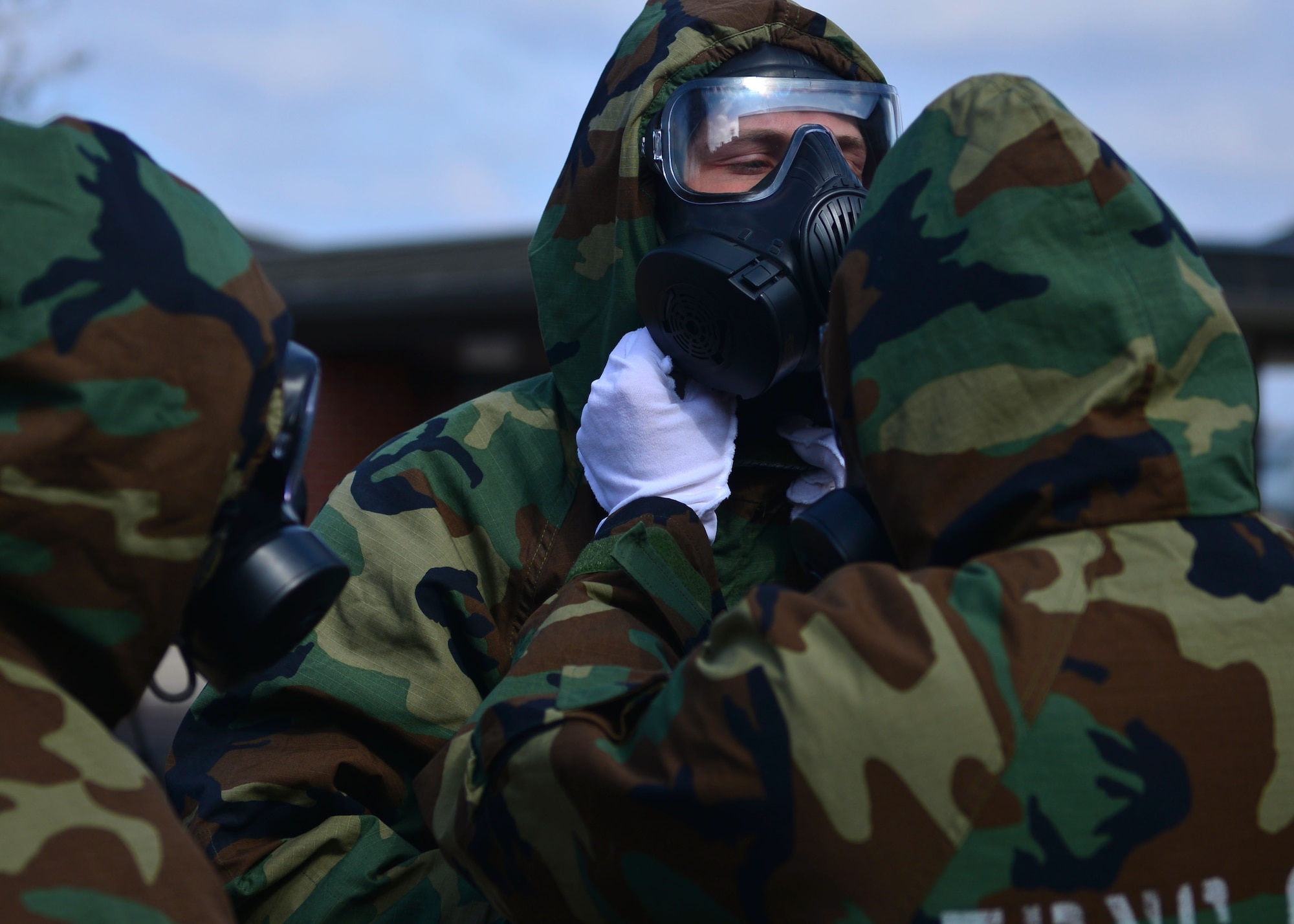 Airmen don MOPP gear.