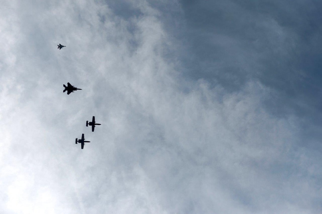 Two A-10 Thunderbolt II aircraft and two F-15 Eagles fly in formation over the full honors funeral for retired Col. Leo Thorsness at Arlington National Cemetery, Arlington, Va., Feb. 14, 2018. Thorsness received the Medal of Honor for his heroic actions in combat. (U.S. Air Force photo by Staff Sgt. Rusty Frank)