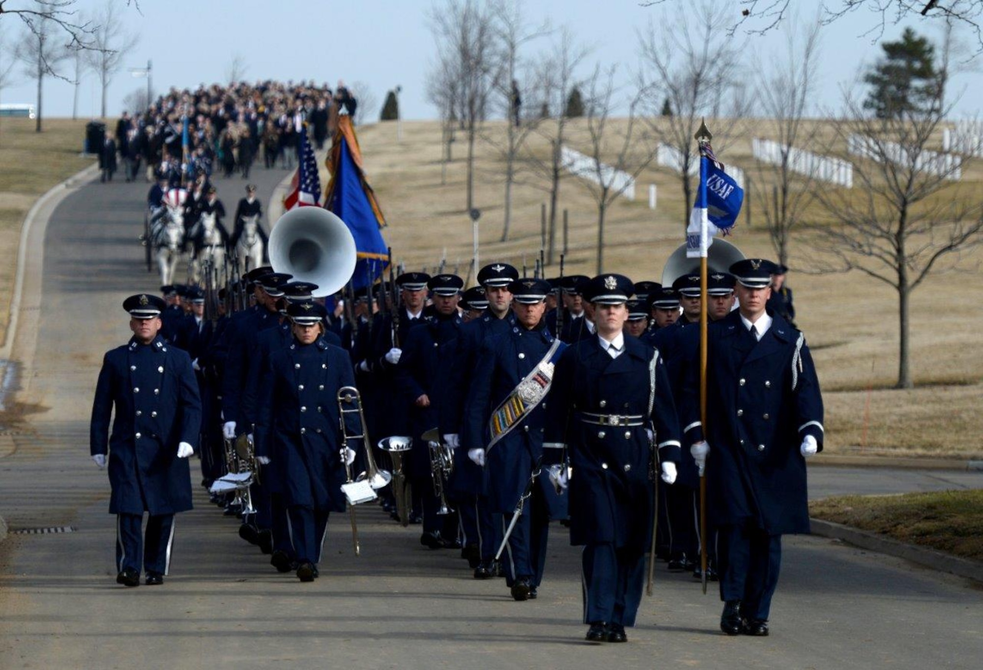 Ceremonial Guardsmen and the Band march toward the gravesite during retired Col. Leo Thorsness's full honors funeral at Arlington National Cemetery, Arlington, Va., Feb. 14, 2018. Thorsness was a Vietnam Prisoner of War and Medal of Honor recipient. (U.S. Air Force photo by Staff Sgt. Rusty Frank)