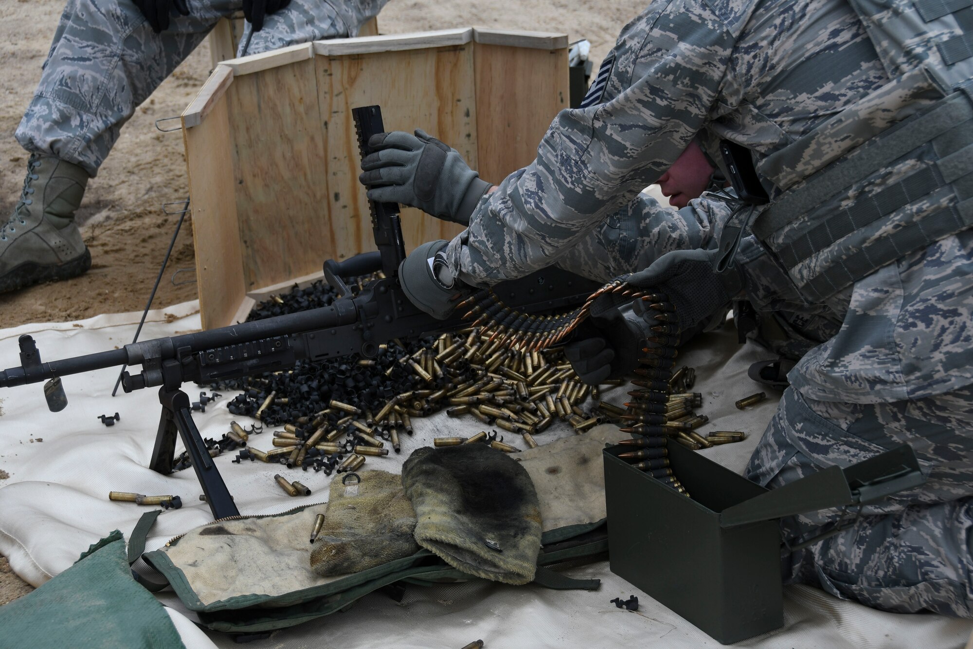 A U.S. Airman assigned to the 307th Security Forces Squadron loads ammunition into a M240B machine gun during annual weapons training at Fort Polk, Louisiana, Feb. 9, 2018.