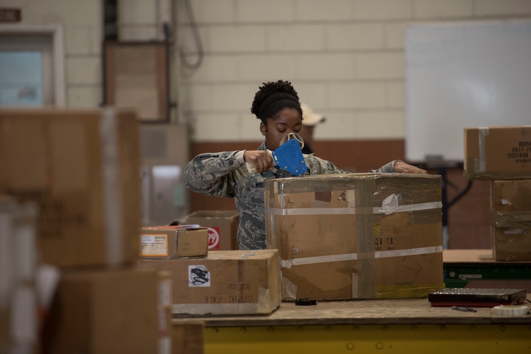 U.S. Air Force Staff Sgt. Bianca Mitchell, 18th Logistics Readiness Squadron Traffic Management Office outbound cargo movement traffic overseer, tapes up cargo for shipment to another installation, Feb. 14, 2018, at Kadena Air Base, Japan. TMO outbound supports more than just Kadena. A key part of their mission is to also support military installations and units around the globe. (U.S. Air Force photo by Senior Airman Omari Bernard)